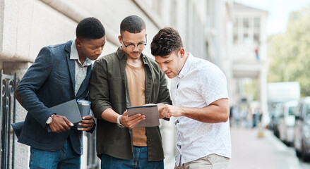 Poster - Team of creative designers checking a website for ux and ui while working for a startup. Group of young guys looking at a homepage on a tablet while developing a new business strategy or mission