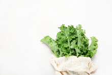 Fresh Green Curly Kale Leaves On Neutral Background.