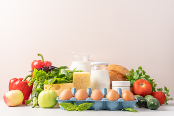 Groceries shopping or food delivery concept. Close up view of eggs, dairy products, vegetables, fruits, bread. Healthy eating