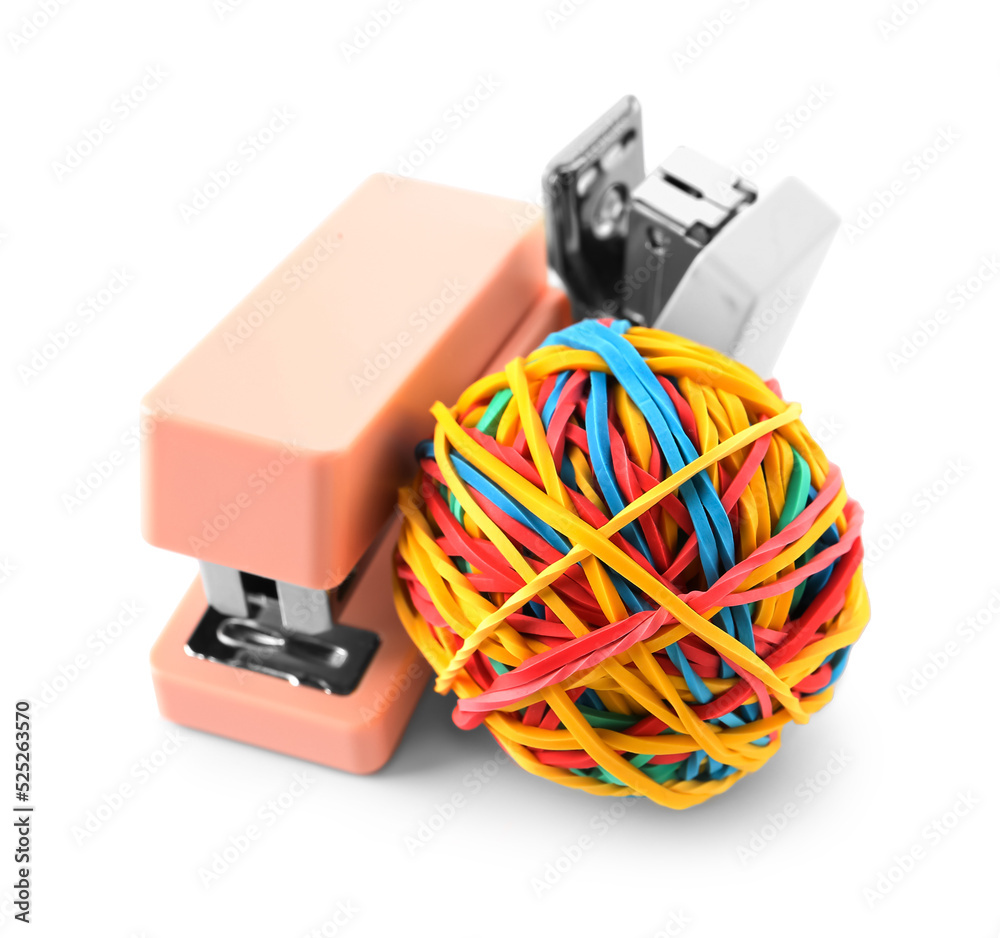 Colorful rubber band ball and staplers on white background