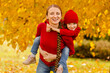 © ShunTerra - happy mother and child in knitted red clothes play and laugh on an autumn walk