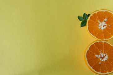 Two orange halves on a yellow background.