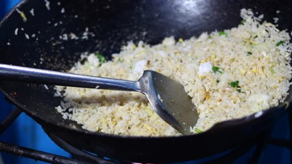 Wall Mural - Preparing Indonesian fried rice in a wok. Making Shrimp Fried Rice in a wok.