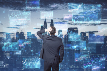 Poster - Back view of young european businessman looking at creative business forex chart hologram on blurry city background. Finance, stock, trade and financial growth. Double exposure.