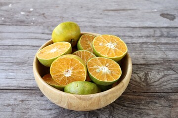 Wall Mural - Fresh orange fruit on wood background