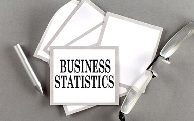 Poster - BUSINESS STATISTICS text written on a sticky with pencil and glasses