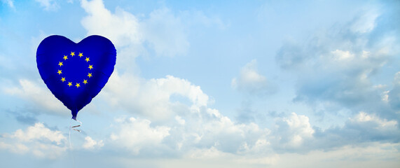 European Union flag on balloon against sky clouds background. Education, charity, emigration, travel and learning in EU concept