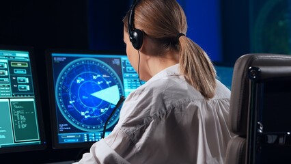 Workplace of the air traffic controllers in the control tower. Team of professional aircraft control officers works using radar, computer navigation and digital maps. Aviation concept.