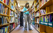 © track5 - Teenage Students, library studies. A college student making use of her school reference library. From a series of related images.