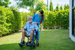 Happy nurse take care senior man on wheelchair at nursing home,Nurse assisting senior age.