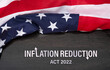 Inflation reduction act of 2022 concept with United States flag on top.