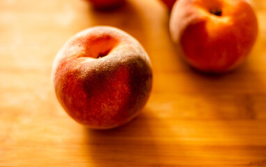 Wall Mural - Ripe peaches on wooden board close up