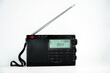 © pro2audio - Modern black shortwave radio with antenna and digital display on a white background