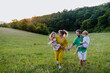 © Halfpoint - Happy young family spending time together outside in green nature.