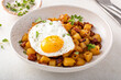 Potato, onion and ham hash topped with fried egg