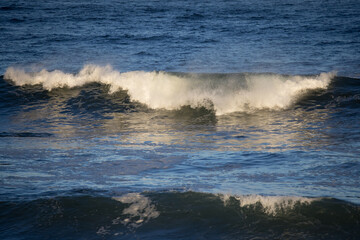 Wall Mural - Ocean waves crashing on a rocky shore