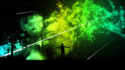 Wall Mural - A man standing on the grass on a hill with a tree, admires the starry sky with a beautiful yellow-green nebula and falling meteors. The concept of the beauty of nature and the universe.