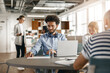 © Kostiantyn - Businesspeople working together in bright office, sitting at desk