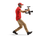 Full Length Profile Shot Of A Camera Operator Using A Stabilizer And Recording With Camera