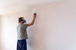 Man sanding wall with sandpaper. Title space at frame.