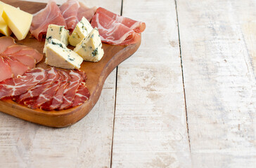 Wall Mural - Appetizers table with differents antipasti, charcuterie, snacks and cheese on cutting board. Buffet party. Top view, copy space