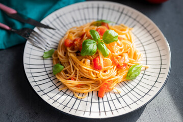 italian pasta in a restaurant with tomato sauce and basil