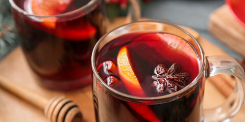 Glass cup of tasty mulled wine on table, closeup