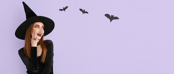 Wall Mural - Beautiful woman dressed as witch for Halloween on lilac background with space for text