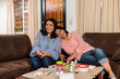 © Paulina - portrait of two smiling women, who are sitting on a sofa