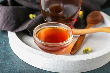 tray with bowl of tasty maple syrup on table, closeup