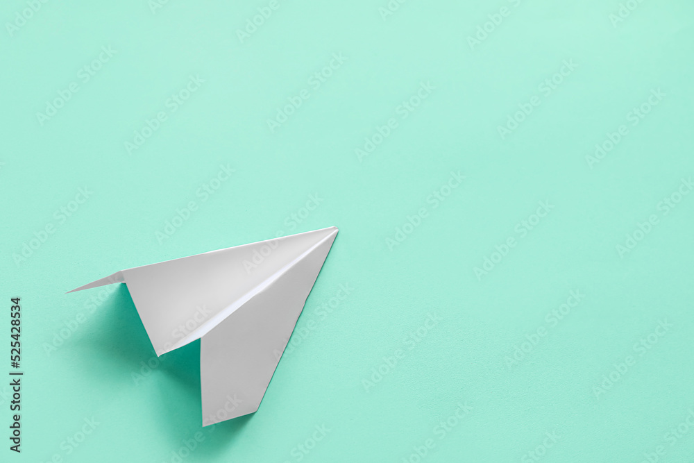 White paper plane on color background