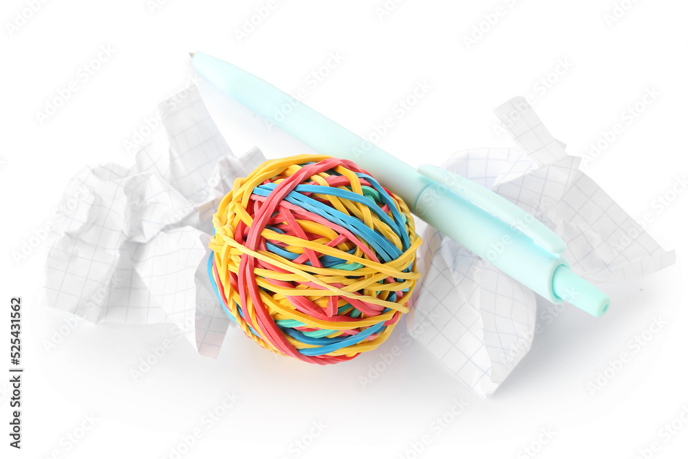 Colorful rubber band ball, crumpled paper and pen on white background