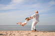 © New Africa - Cute little girl with grandfather spending time together on sea beach