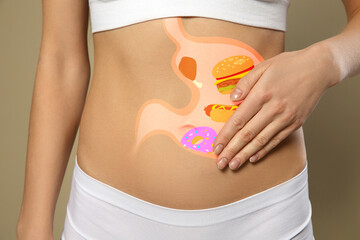 Wall Mural - Woman with image of stomach full of junk food drawn on her belly against beige background, closeup. Unhealthy eating habits