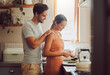 © K Abrahams/peopleimages.com - Romantic, caring and loving young couple supporting each other while preparing a meal in the kitchen. Man and woman in a happy, stressless and relaxed relationship together cooking at home.