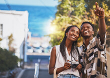 Photographer Couple On Summer Vacation Or Holiday Abroad And Tourism With Lens Flare, Ocean And Street Background. Black People, Man And Woman Looking At Tourist Destination For Travel Photography