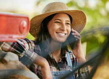 Agriculture, sustainability and farmer talking on phone call on a break while working on a farm. Happy sustainable farmland worker or agro woman having mobile conversation in the countryside