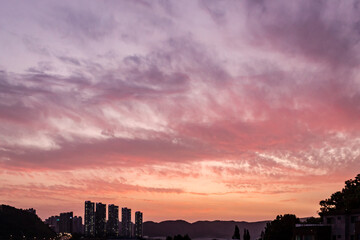 Wall Mural - dramatic pink and purple sunset clouds sky over the south korea rural countryside