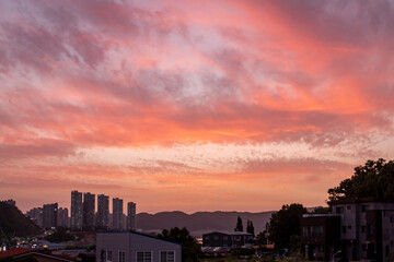 Wall Mural - dramatic pink and purple sunset clouds sky over the south korea rural countryside