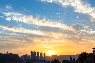 Wall Mural - dramatic golden sunset clouds sky over the south korea countryside