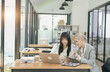 © aekachai - Business strategy investment concept Two asian businesswoman confident and discussing at office
