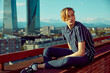 © ADDICTIVE STOCK - Handsome young male sitting on roof