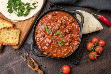 Wall Mural - Bean and corn soup or ragout, red bean stew  on a wooden background. Food Protein Vegan dish