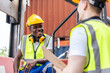 © Kawee - African American and Caucasian man worker work in container terminal
