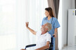 © Montri - Nurse doctor senior care caregiver help assistence retirement home nursing elderly health. Elderly man with caregiver in nursing home. happy senior man. concept of caring for the elderly at home.