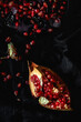 © ADDICTIVE STOCK - Fresh and red pomegranate on dark background