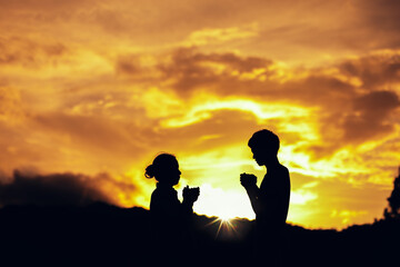Sticker - Silhouette of mother and son praying and worship to God at sunset. Hands in prayer. Christian Religion concept background. Copy space for your individual text.