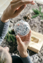 Closeup View Of Woman Hands Holding A A Christmas Tree Ball Ornament
