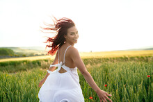 Happy Woman With Flying Hair In Wheat Field