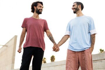 Wall Mural - Gay couple embracing and showing their love. LGBT community.